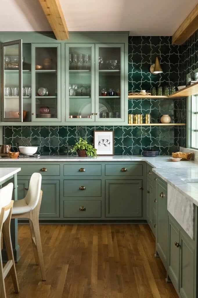 a kitchen with green cabinets and white chairs