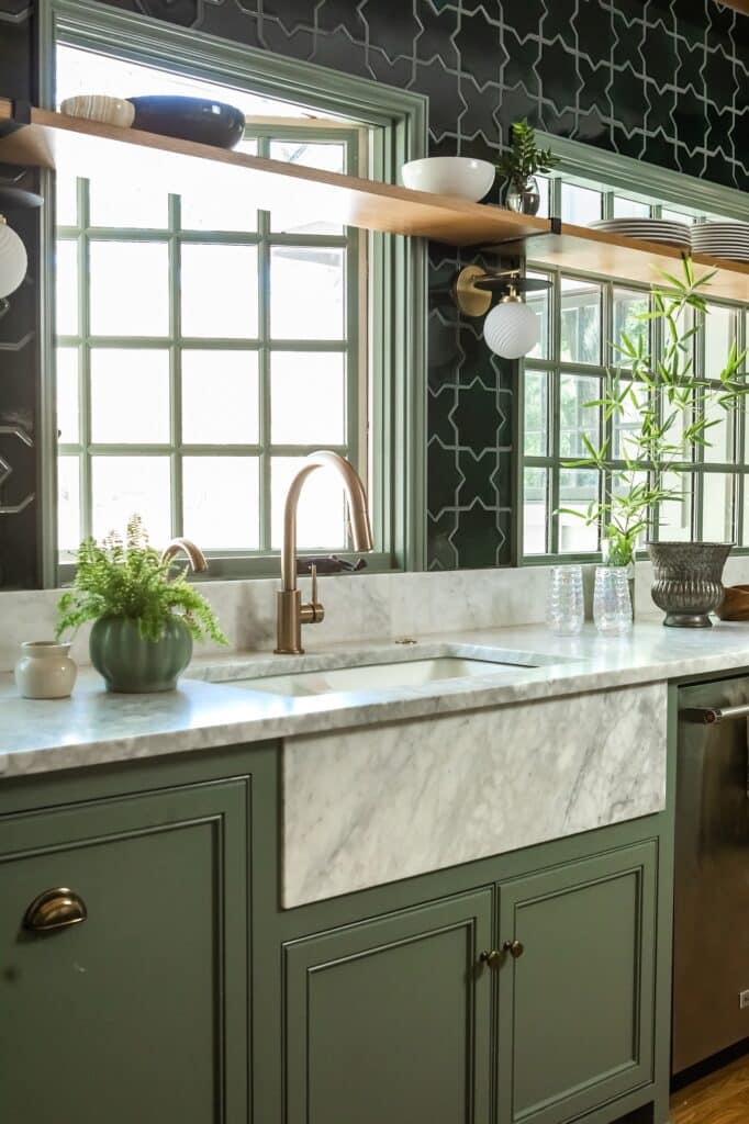 a kitchen with green cabinets and a sink