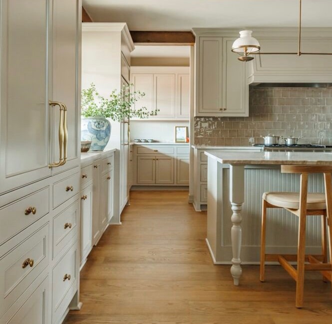 a kitchen with white cabinets and a wood floor