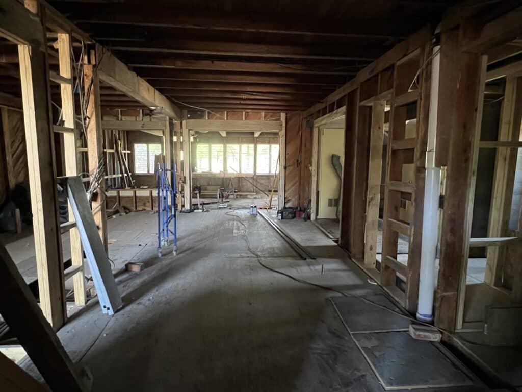 a room with wood beams and ladders