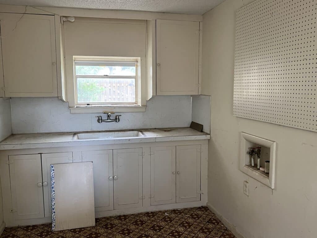 a kitchen with white cabinets and a sink