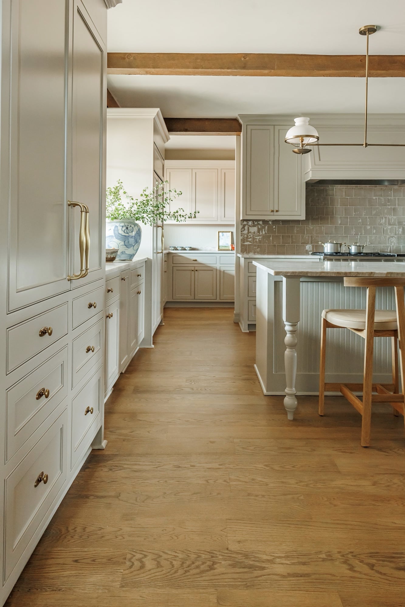 a kitchen with white cabinets and a wood floor